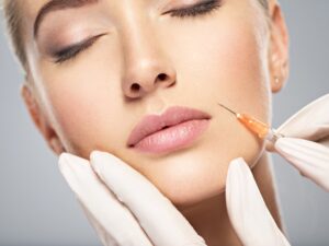 A woman receiving an injection of filler in her face